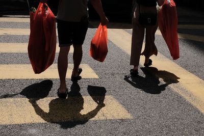 Low section of people walking on road