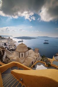 High angle view of buildings by sea against sky