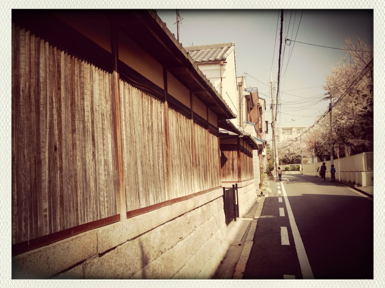 transfer print, architecture, built structure, building exterior, auto post production filter, the way forward, transportation, sky, diminishing perspective, street, city, vanishing point, day, incidental people, outdoors, house, residential structure, sunlight, sidewalk, building