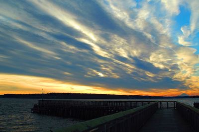 Pier on sea at sunset