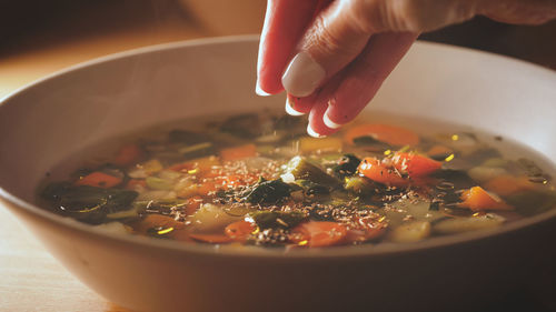 Close-up of person hand in bowl