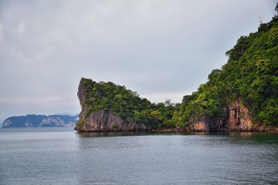Scenic view of sea and mountains against sky