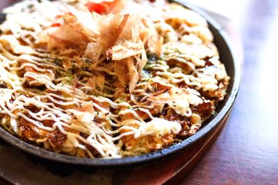 Close-up of okonomiyaki in bowl on table