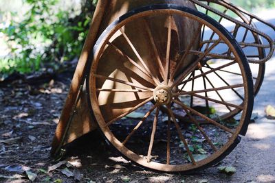 Rusty wheelbarrow on field
