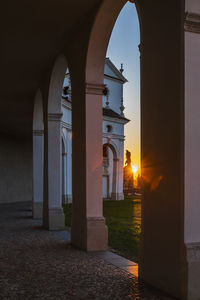 Archway of historic building against sky during sunset