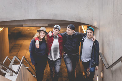 Portrait of smiling friends on staircase