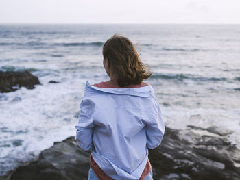 Rear view of woman looking at sea shore