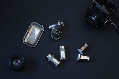 High angle view of camera on table against black background