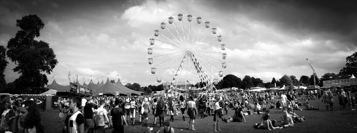 Panoramic view of crowd at amusement park in city