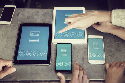 High angle view of female pointing at digital tablet in cafe