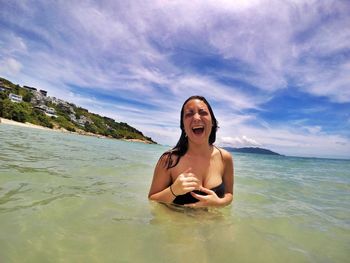 Portrait of smiling young woman on beach