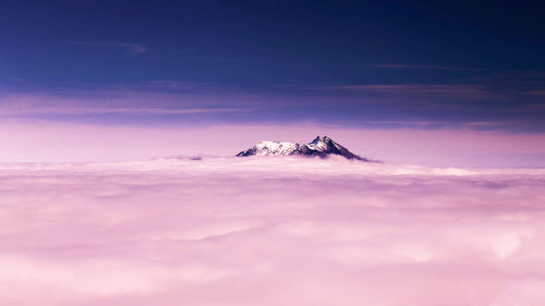 Scenic view of snowcapped mountain against sky during sunset