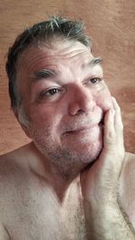 Close-up portrait of shirtless man