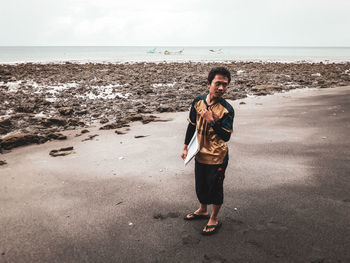 Full length of man standing on beach