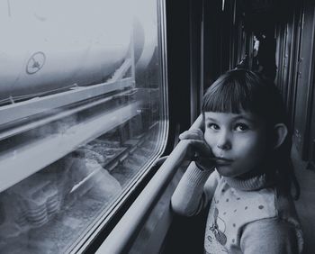 Woman looking through train window