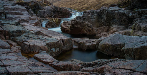 High angle view of stream amidst rock formation