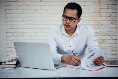 Young man using laptop on table