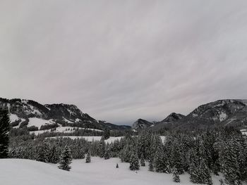 Scenic view of snow covered mountains against sky