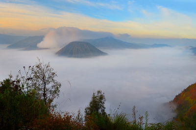 Scenic view of mountains against cloudy sky