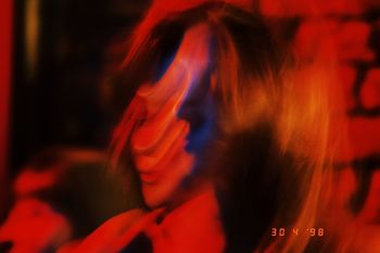 HIGH ANGLE VIEW OF WOMAN DANCING AT NIGHTCLUB