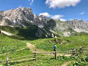 Man walking on mountain against sky