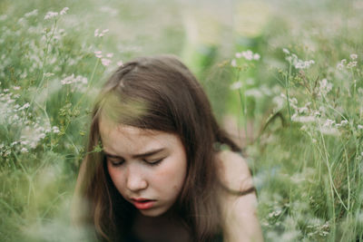 Portrait of beautiful young woman in field