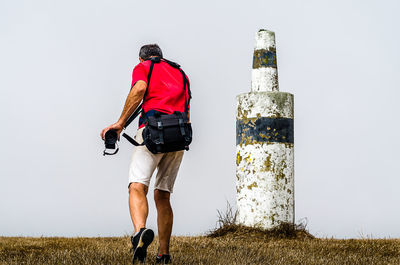 Rear view of man standing on field