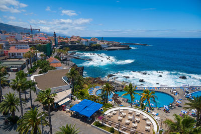 High angle view of townscape by sea against sky