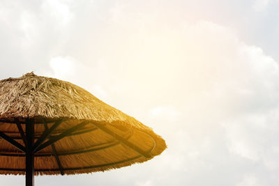 Low angle view of parasol against sky