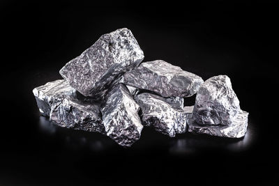 Close-up of water drops on rock against black background