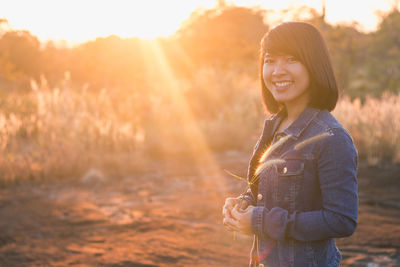Portrait of smiling young woman outdoots during sunset