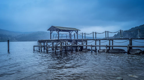 Pier over lake against sky