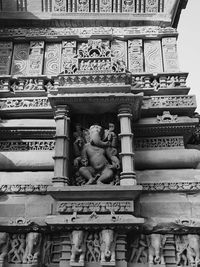 Low angle view of statue against building