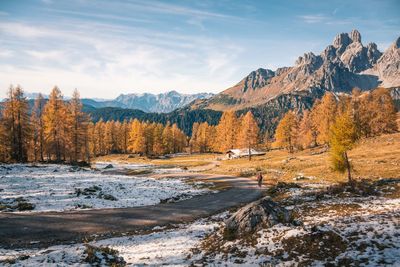 Scenic view of snow covered land and mountains against sky