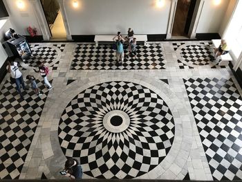 High angle view of people standing on tiled floor