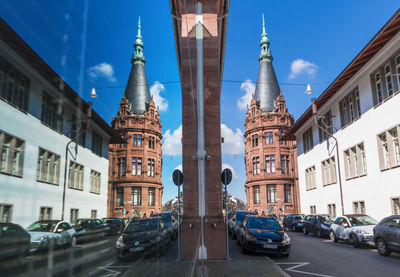 Cars on street amidst buildings in city