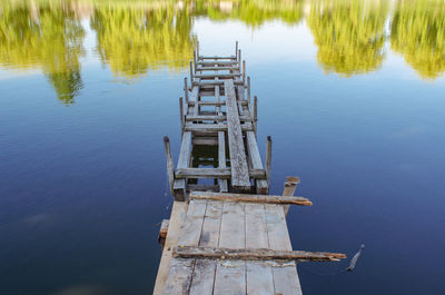 High angle view of abandoned wooden post in lake