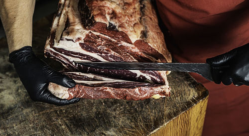 Butcher preparing and cutting meat