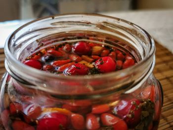 High angle view of strawberries in glass jar on table