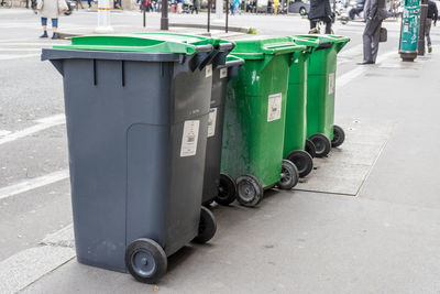 Garbage bin on sidewalk in city