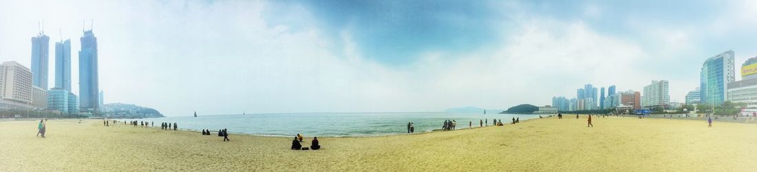Panoramic view of beach and buildings against sky