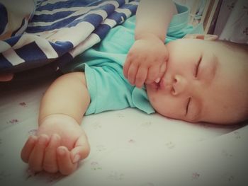 Close-up of baby sleeping on bed