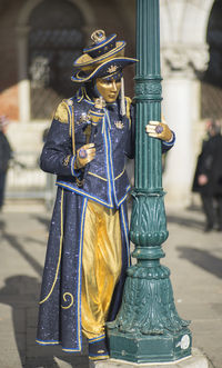 Full length of person in venetian mask and costume during venice carnival