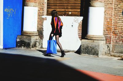 Full length of woman standing in front of building