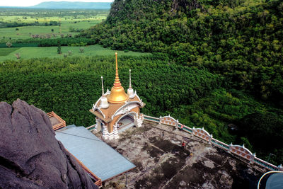 High angle view of cross amidst trees and buildings