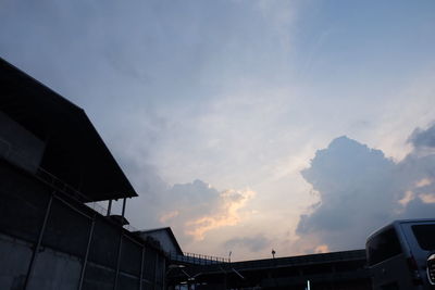 Low angle view of silhouette buildings against sky