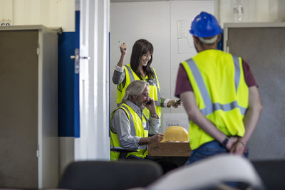 Construction worker and engineer discussing project in site office