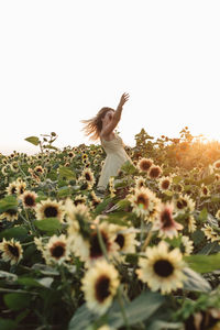 Low angle view of woman standing on field against clear sky