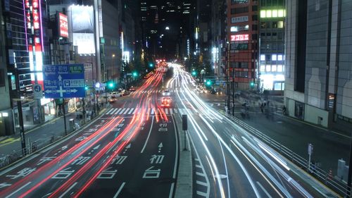 Light trails on road in city at night