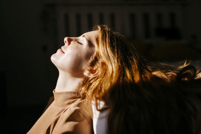 Portrait of a young woman looking away